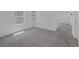 Bedroom featuring gray carpet, white walls, large window, and floating shelves at 10273 Fragrant Apple Ct, Las Vegas, NV 89141