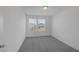 Bedroom featuring carpeted floors and two windows at 10273 Fragrant Apple Ct, Las Vegas, NV 89141