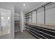 Walk-in closet featuring shelving and drawer space, carpet flooring, and a closet organizer at 10273 Fragrant Apple Ct, Las Vegas, NV 89141