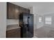 Modern kitchen with granite countertops and black refrigerator at 10273 Fragrant Apple Ct, Las Vegas, NV 89141