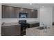 Stylish kitchen featuring granite countertops, dark wood cabinets, and stainless steel range at 10273 Fragrant Apple Ct, Las Vegas, NV 89141