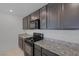 Well-lit kitchen featuring granite counters and stainless appliances at 10273 Fragrant Apple Ct, Las Vegas, NV 89141