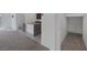 Open living space featuring carpet, granite countertop island, stainless steel sink and a pantry at 10273 Fragrant Apple Ct, Las Vegas, NV 89141