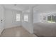 Open-concept living room with large windows, neutral paint, and seamless transition to the backyard patio at 10273 Fragrant Apple Ct, Las Vegas, NV 89141