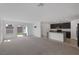 Spacious living room offers lots of natural light, neutral carpeting, with views into the kitchen and backyard patio at 10273 Fragrant Apple Ct, Las Vegas, NV 89141