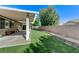 Spacious backyard with lush green grass and a covered patio, perfect for outdoor living at 10389 Walking View Ct, Las Vegas, NV 89135