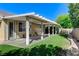 Backyard featuring a grassy area, patio cover, and a block wall for privacy at 10389 Walking View Ct, Las Vegas, NV 89135