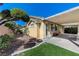 Backyard featuring beautiful landscaping, an open patio, and a covered patio with bench at 10389 Walking View Ct, Las Vegas, NV 89135