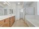 Bright bathroom with double sinks, a separate shower, and a soaking tub, offering a luxurious space at 10389 Walking View Ct, Las Vegas, NV 89135