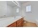 Bathroom featuring a white sink vanity with wood cabinets and tiled floors and a large mirror at 10389 Walking View Ct, Las Vegas, NV 89135