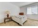 Bedroom with carpet flooring, decorated with side tables, dresser, lamp and a floral bedspread at 10389 Walking View Ct, Las Vegas, NV 89135
