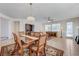 Elegant dining room with a chandelier over a wood table on an ornate floral rug with an adjacent living area at 10389 Walking View Ct, Las Vegas, NV 89135