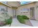 Inviting home entrance with decorative glass front door and manicured bushes at 10389 Walking View Ct, Las Vegas, NV 89135