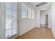 Bright hallway featuring tile flooring, natural light from a door and windows with white trim and leads to other rooms at 10389 Walking View Ct, Las Vegas, NV 89135