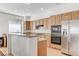 Modern kitchen featuring stainless steel appliances, granite counters, and light wood cabinetry at 10389 Walking View Ct, Las Vegas, NV 89135