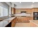 Well-lit kitchen featuring stainless steel appliances and stone countertops at 10389 Walking View Ct, Las Vegas, NV 89135
