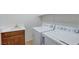 Laundry room featuring a washer, dryer, and sink with a dark wood vanity at 10389 Walking View Ct, Las Vegas, NV 89135