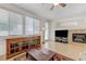 Bright living room featuring built-in cabinetry, fireplace, large windows, and tiled floors, offering a relaxed atmosphere at 10389 Walking View Ct, Las Vegas, NV 89135