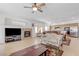 Comfortable living room with a fireplace and TV area, seamlessly flowing into the dining and kitchen spaces at 10389 Walking View Ct, Las Vegas, NV 89135