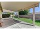 Covered outdoor patio with concrete flooring, seating and well-maintained landscaping at 10389 Walking View Ct, Las Vegas, NV 89135