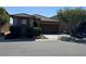Charming single-story home featuring a well-manicured front yard and a two-car garage at 10590 Natural Bridge St, Las Vegas, NV 89179