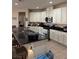 This spacious kitchen features modern appliances, granite counters, and bar stool seating at the counter at 10590 Natural Bridge St, Las Vegas, NV 89179
