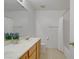 Bathroom with double sinks, wood cabinets, and shower tub combo at 1421 Via Savona Dr, Henderson, NV 89052