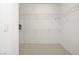 Walk-in closet featuring wire shelving and neutral carpet at 1421 Via Savona Dr, Henderson, NV 89052