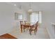 Traditional dining room with neutral tones, wooden table set, chandelier, and large window at 1421 Via Savona Dr, Henderson, NV 89052