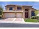 Stunning two-story home featuring a tile roof, manicured lawn, and a spacious three-car garage at 1421 Via Savona Dr, Henderson, NV 89052