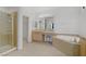 Main bathroom featuring tiled shower, double sinks, walk in closet and a soaking tub at 1421 Via Savona Dr, Henderson, NV 89052