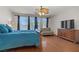 Spacious main bedroom with wood floors, ceiling fan, and view of the backyard at 1421 Via Savona Dr, Henderson, NV 89052
