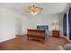 Comfortable main bedroom with fan, hardwood floors, and a view to the ensuite at 1421 Via Savona Dr, Henderson, NV 89052