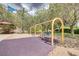 Neighborhood playground featuring swings, picnic table, and mature landscaping at 1421 Via Savona Dr, Henderson, NV 89052