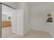 Walk-in closet featuring white walls, shelving and carpeted floors at 1421 Via Savona Dr, Henderson, NV 89052