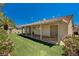 View of the backyard with a covered patio, artificial turf, and well-maintained landscaping at 1574 Livingston Dr, Henderson, NV 89012