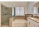 Bright bathroom featuring a glass enclosed shower, soaking tub, and shuttered windows at 1574 Livingston Dr, Henderson, NV 89012