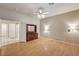 Bedroom featuring wood floors, lighted sconces and lighted ceiling fan at 1574 Livingston Dr, Henderson, NV 89012