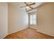 An empty bedroom with wood-look floors, neutral walls, and a window with plantation shutters at 1574 Livingston Dr, Henderson, NV 89012