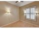 Bedroom featuring three lighted sconces, hardwood flooring, ceiling fan and shuttered window at 1574 Livingston Dr, Henderson, NV 89012