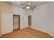 Bedroom with wood-look flooring, a ceiling fan, and a closet with adjustable shelving at 1574 Livingston Dr, Henderson, NV 89012