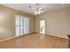 Spacious bedroom featuring wood floors, shuttered windows and lighted ceiling fan at 1574 Livingston Dr, Henderson, NV 89012