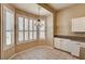 Sun-drenched breakfast nook with tiled floor, plantation shutters and hanging light fixture at 1574 Livingston Dr, Henderson, NV 89012