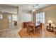 Inviting dining area with wood table, stylish chairs, and lots of natural light from the window at 1574 Livingston Dr, Henderson, NV 89012