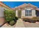 Charming single-story home with desert landscaping and a walkway leading to the front door at 1574 Livingston Dr, Henderson, NV 89012