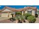Well-maintained single-story home with desert landscaping and a three-car garage at 1574 Livingston Dr, Henderson, NV 89012