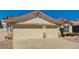 Spacious three-car garage with a wide driveway, providing ample parking and enhancing the curb appeal of this lovely home at 1574 Livingston Dr, Henderson, NV 89012