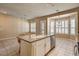 Spacious kitchen island with seating, tiled floor, and natural light from the windows at 1574 Livingston Dr, Henderson, NV 89012