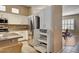 Kitchen features stainless refrigerator, granite counters, white cabinets and eating nook at 1574 Livingston Dr, Henderson, NV 89012