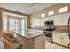 Kitchen with white cabinets, granite countertops, a center island, and bar stool seating at 1574 Livingston Dr, Henderson, NV 89012
